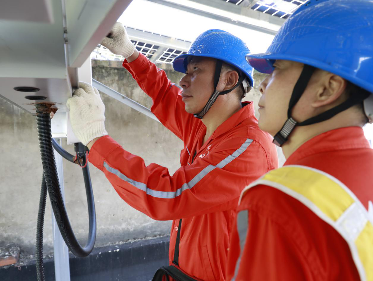 8月20日，國(guó)網(wǎng)重慶綦江供電公司工作人員為村民檢查光伏設(shè)備。（袁巧攝）.png